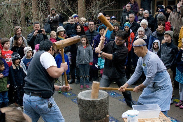 Islanders help pound a mass of steamed rice in a mortar called an “usu” during last year's Mochi Tsuki celebration at IslandWood.