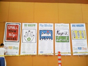 Conner Mackin helps post the last of the Street Smarts communication posters at the Winslow Mall. The contract for the team ended June 30.