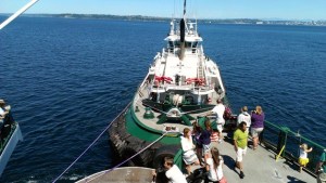 Passengers on the ferry MV Tacoma watch as a tugboat brings the disabled ferry to Bainbridge Island.