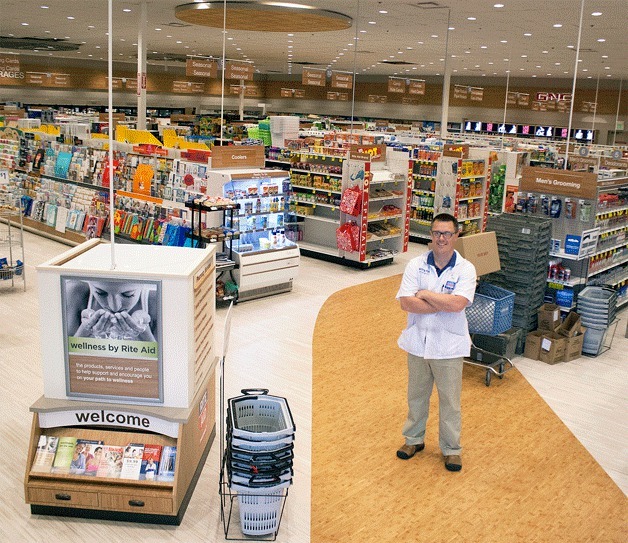 Pharmacy Manager Justin Ausmeier stands at the entrance of the newly remodeled Rite Aid on High School Road that includes new floors