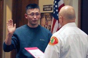 New Bainbridge Fire Commissioner YongSuk Cho takes the oath of office Wednesday at Station 21.