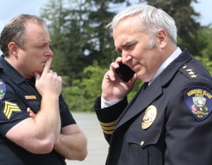 Bainbridge Police Chief Matthew Hamner (right) and Bainbridge Sgt. Trevor Ziemba stand outside Bainbridge High School Wednesday as police officers search the school after a 911 call claimed a student was armed with a gun inside the cafeteria.