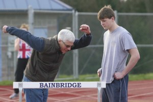 Assistant Coach Dean Tarbill counsels Spartan senior Jay Terry on his hurdling technique during track practice at Spartan Stadium.