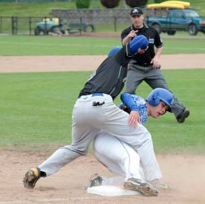 Bainbridge’s Gareth Grindeland slides into third during the Spartans’ bout against Ferndale