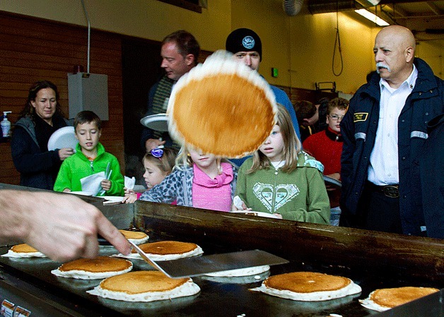 Firefighter Kyle Moerke does some fancy cooking tricks at the 17th annual Bainbridge Island Volunteer Firefighters Association Pancake Breakfast.