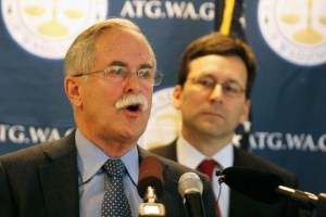 Commissioner of Public Lands Peter Goldmark talks to reporters at a press conference Wednesday while state Attorney General Bob Ferguson listens.