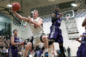 BHS senior Blake Swanson reclaims the ball in the air during Friday’s high-flying basketball battle against Garfield High. The Spartans ultimately lost 76-61.