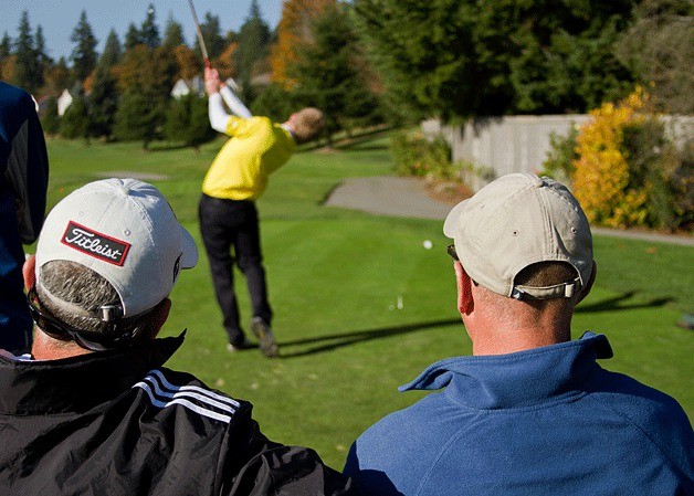 Spartan Head Coach Tom Zuzelski and Seattle Prep Head Coach Tim Reilly watch as Bainbridge senior Andy Jonson tees off on the first hole during a game Thursday