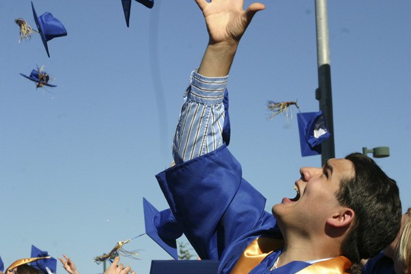 Jeffrey Yalung happily sends his blue cap skyward as graduation ceremonies ended Saturday afternoon at Bainbridge High School. Thousands of well-wishers filled BHS stadium to watch 345 Banbridge and Eagle Harbor High School students graduate under blue skies and temperatures in the high-70s.