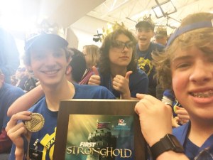 Members of the Spartronics Team 4915 gather around their “Excellence in Engineering” award.