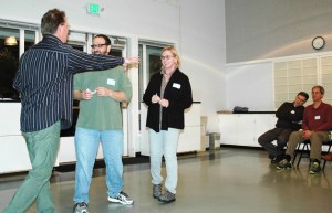 Improvisation coach Michael Schmitt guides Toastmasters Bryan Lynn and Mary Ann Proctor through their scene.