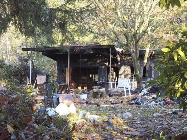 Bainbridge Island firefighters investigate do determine the cause of a fire that destroyed a home on Washington Avenue NE.