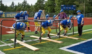 The Bainbridge Spartans practice this week under the watchful eye of Coach Andy Grimm in preparation for an on-the-road battle against Black Hills High.