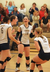 The Spartan volleyball team celebrates their win against Eastside Catholic in the Metro League Volleyball Tournament.