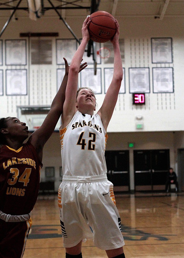 A bit of a stretch: BHS senior post Nancy Karreman grabs for a rebound during the final home game of the regular season Friday
