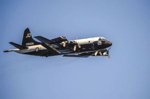 Navy Lt. Schuyler Boone pilots a specially painted P-3C Orion from Naval Air Station Whidbey Island over Lake Washington during the Seafair Airshow on Friday