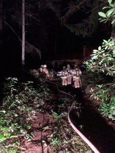 Bainbridge firefighters stand outside a home where a house fire was reported Monday.