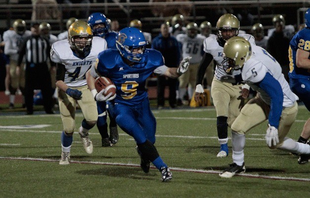 BHS junior running back Carter Daniels fends off a few of the Bremerton Knights during the Spartans’ final game of the season Friday.