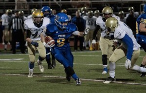 BHS junior running back Carter Daniels fends off a few of the Bremerton Knights during the Spartans’ final game of the season Friday.