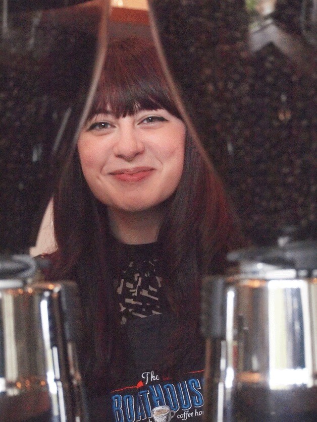 Barista Miranda Feldtman stands behind coffee grinders at the BoatHouse at Pleasant Beach Village.