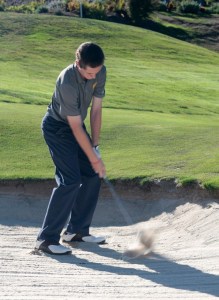 Andy Becker swings himself out of the sand at Wing Point Golf & Country Club during the Spartans’ home match against Bishop Blanchet Tuesday.