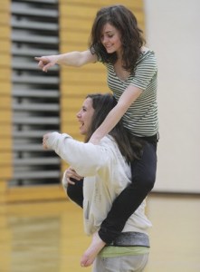 Emma Marshall (top) and Natalia Distefano have some fun as they work on their routine at practice Wednesday.
