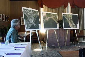 Project manager Larry Ward listens as engineering manager Chris Hammer speaks to roughly 40 Wing Point residents on designs for a new sewer main Monday evening.