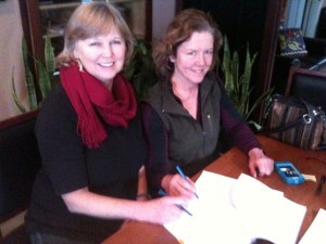 Wendy Tyner of Friends of the Farms signs a lease with Farmer Betsey Wittick.