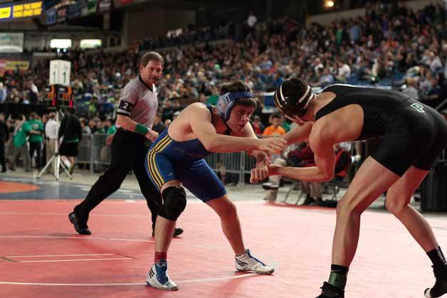 Bainbridge senior wrestler Joaquin Gurza competes in his first match of the 2015 Mat Classic XXVI State Wrestling Tournament at the Tacoma Dome..