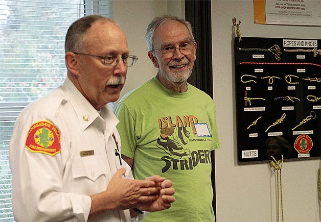 Bainbridge Island Fire Department Assistant Chief Luke Carpenter talks with heart-attack survivor Alan Lindstrum before the start of a recent BIFD CPR class.