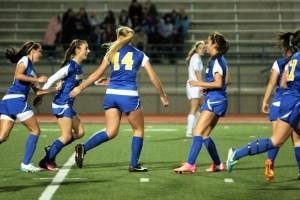 Riley Gregoire is congratulated by her fellow Spartans after scoring the second goal in Bainbridge’s 3-0 first-round win in the state 3A girls soccer playoffs over Meadowdale at Edmonds Stadium.