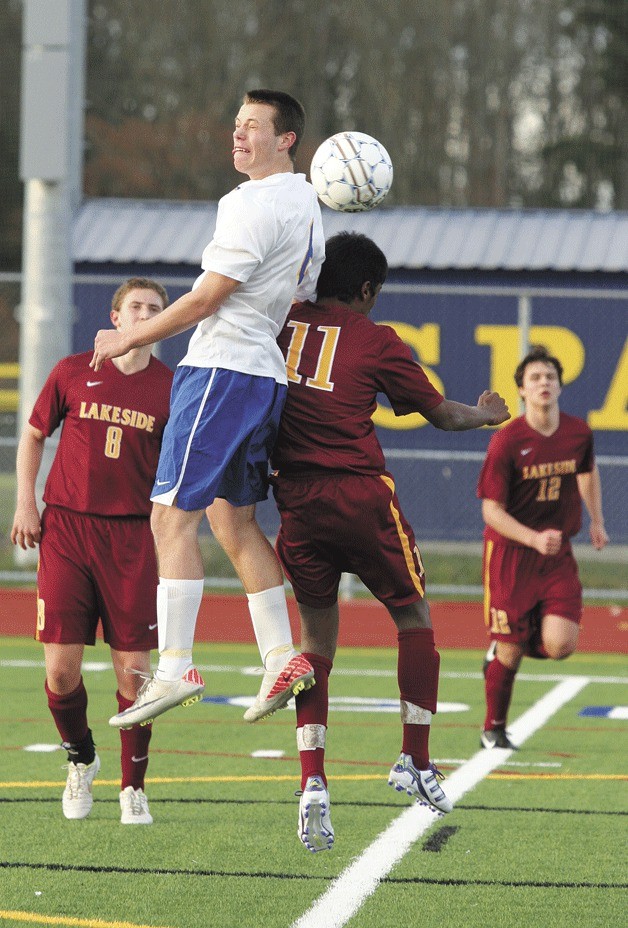 Spartan player Peter Fawley beats Gaby Joseph of Lakewood to the ball during Bainbridge’s 4-1 win last week.