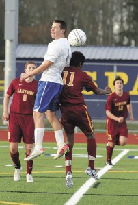 Spartan player Peter Fawley beats Gaby Joseph of Lakewood to the ball during Bainbridge’s 4-1 win last week.