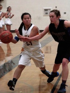 BHS senior guard Sydney Gibbs drives down the court and around the defenses of the Sequim Lady Wolves during the Spartans' first game of the season.