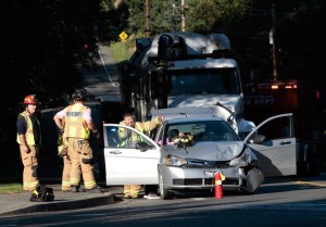 Bainbridge firefighters talk to a driver involved in a car crash Monday morning on High School Road.
