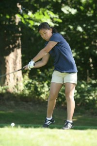 DD Madigan tees off at the start of action against Nathan Hale Tuesday at Wing Point Golf and Country Club. Madigan was the medalist in the Spartan win.