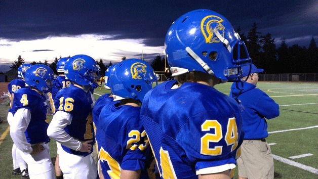 The Spartans watch from the sidelines as Bainbridge battles O'Dea Friday night at Memorial Stadium.