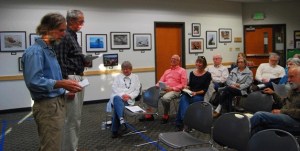 Ron Peltier and Charles Schmid explain to fellow activists the next steps for supporting responsible development on Bainbridge Island.