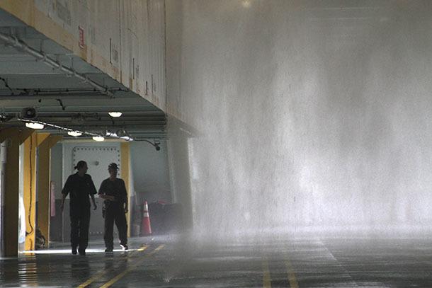 A Coast Guard marine inspector and an Eagle Harbor Maintenance Facility worker confirm that all the sprinkler heads on the car deck of the M/V Salish are operational as part of the vessel’s annual safety inspection last week.