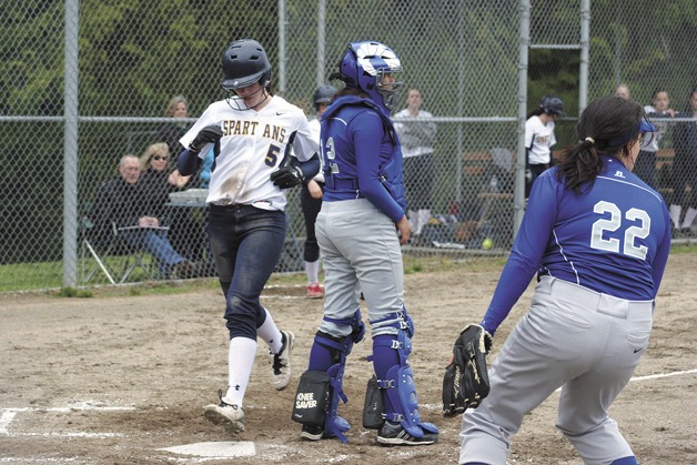 Erin Kinney crosses home plate for another run in the Spartans’ home win against Ingraham.