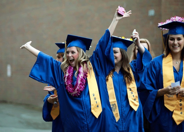 Graduating BHS senior Mary Boynton strikes a pose for the camera as the class of 2014 makes their way to the stadium Saturday