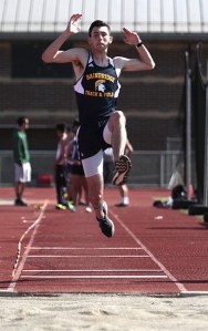 Brandon Swindle mid-air in the long jump event at last week’s final home track meet.