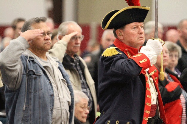 Veterans salute the American flag as it passes at the start of the 11th annual Kitsap County Veterans Day ceremony at the Kitsap County fairgrounds.