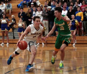 Spartan senior guard Reed Thomas drives around Roosevelt's defenses Tuesday.