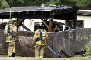 Bainbridge firefighters take a break after extinguishing a blaze at Eagledale Park Thursday.
