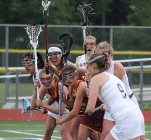 Lakeside defenders eye Ellen Carpenter as she prepares to bring the ball back into play after a foul in the Lions-Spartans playoff matchup Monday.