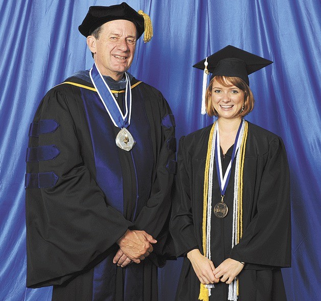 Outstanding Graduate Sophie Wenzlau stands next to Western Washington University President Bruce Shepard.