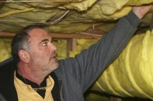 Lead home energy advisor Rick Blumenthal points out energy concerns during an energy assessment.
