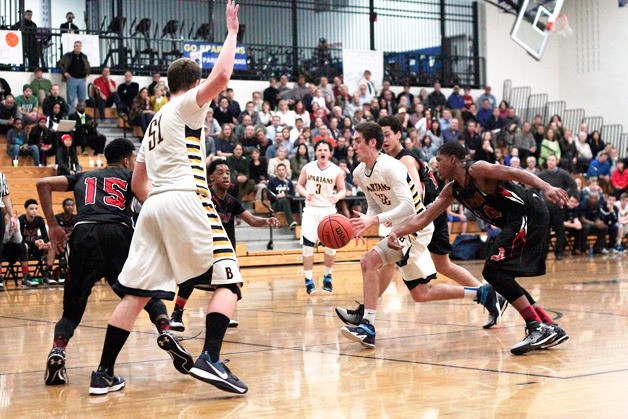 Spartan senior Ben Beatie drives the ball toward the hoop and through Cleveland’s defensive efforts Tuesday. Beatie was the game’s lead points earner with a final night total of 22.