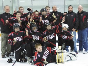 The West Sound Warriors gather on the ice to celebrate their State B Pee Wee Championship.
